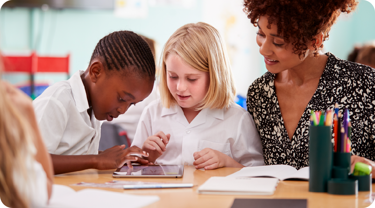 A teacher leads a lesson in front of an engaged elementary classroom